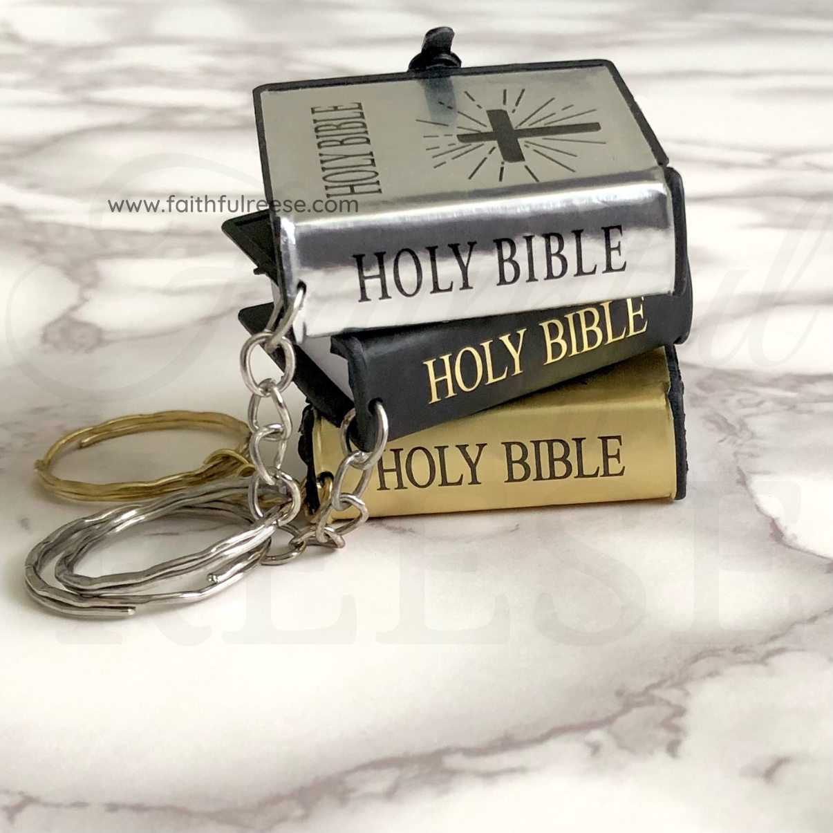 Bible keychains in silver, black, and gold.